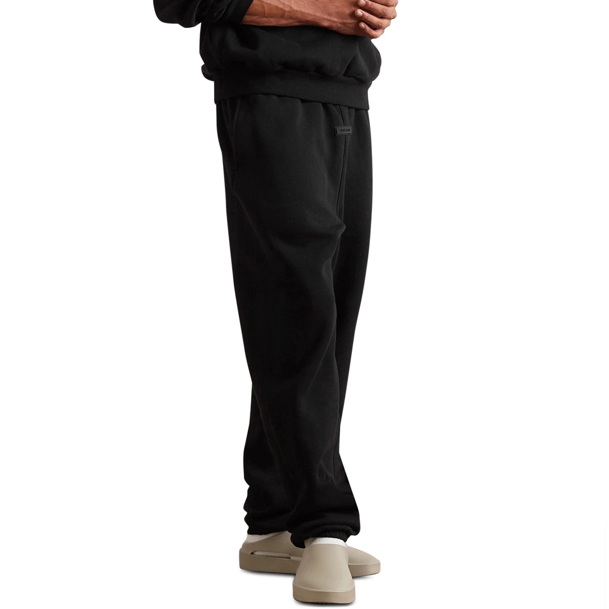 Model front view of Fear Of God Essentials Jet Black Sweatpants